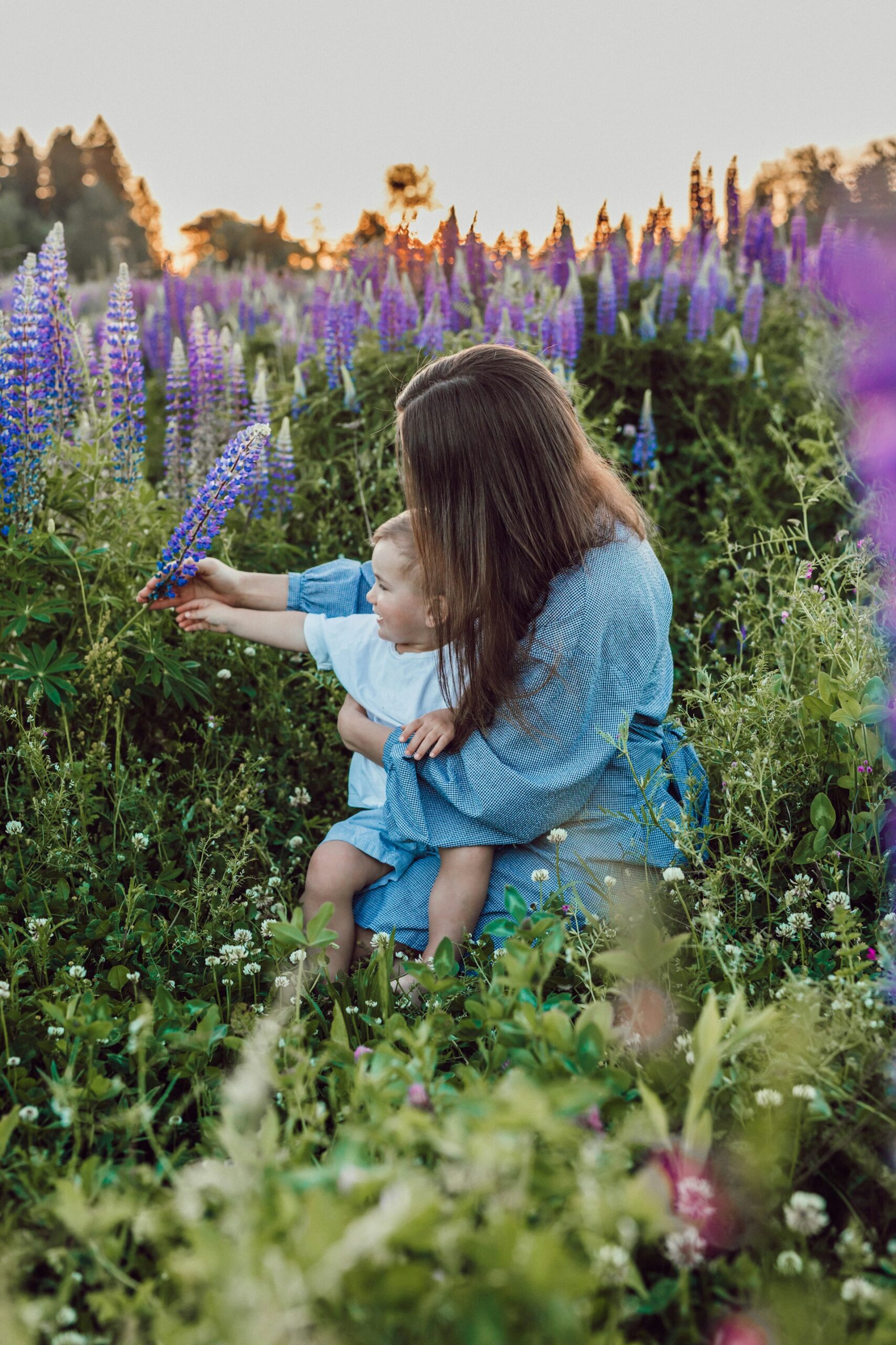 A women and her child in a meadow surrounded by lavender 